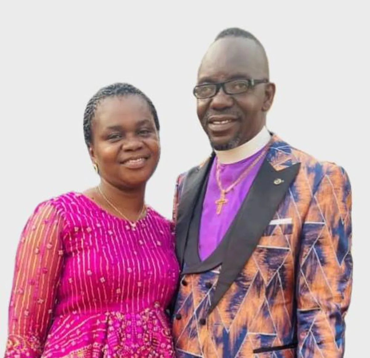 woman staring directly at camera near pink wall